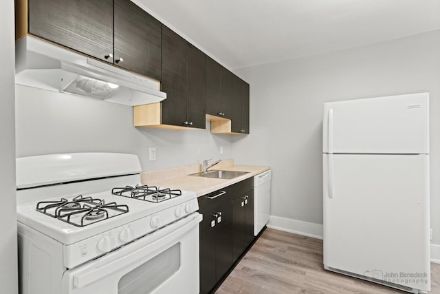 kitchen featuring white appliances, light hardwood / wood-style floors, and sink