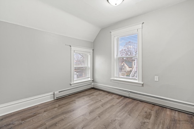 bonus room featuring vaulted ceiling and light wood-type flooring