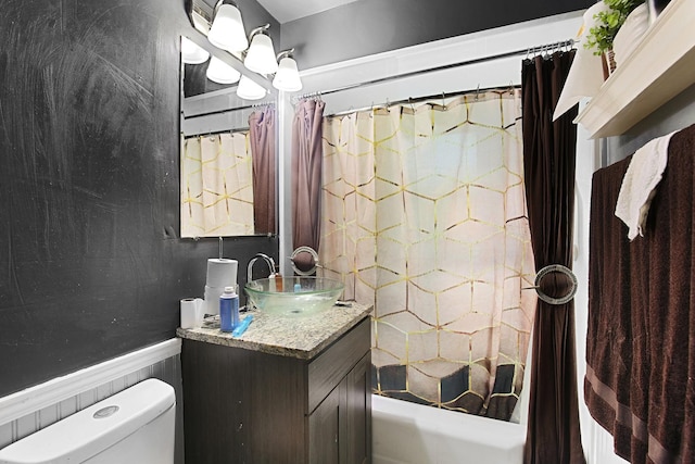 full bathroom featuring shower / bath combo with shower curtain, vanity, and toilet