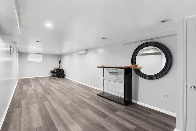 basement with hardwood / wood-style flooring