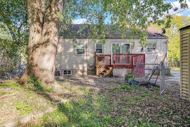 rear view of property with a wooden deck