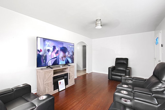 home theater room with dark wood-type flooring