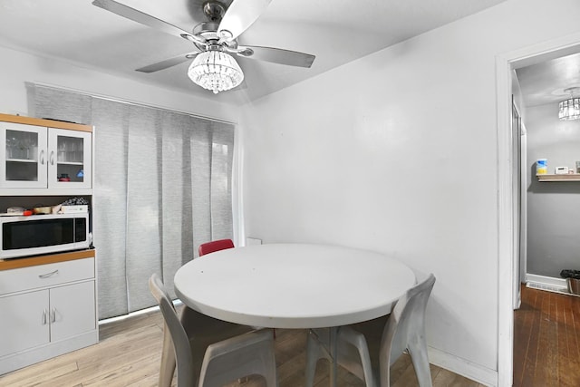 dining space featuring ceiling fan and light hardwood / wood-style floors