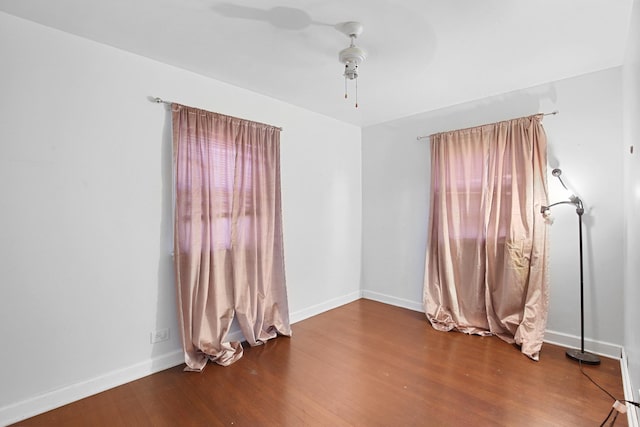 empty room with ceiling fan and wood-type flooring