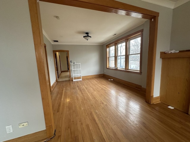 unfurnished living room with light hardwood / wood-style floors and ornamental molding