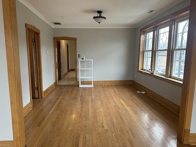 empty room with light hardwood / wood-style flooring