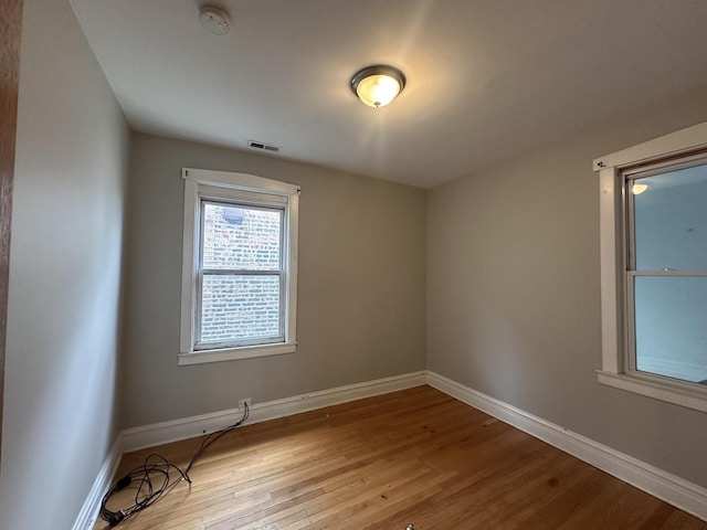 unfurnished room with light wood-type flooring