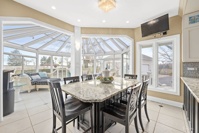 sunroom / solarium featuring a notable chandelier