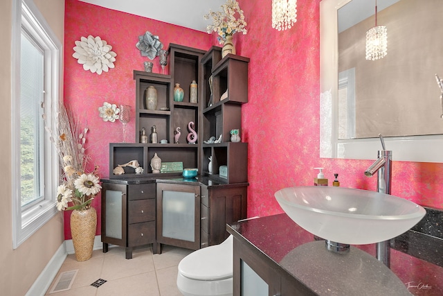 bathroom featuring tile patterned flooring, vanity, and toilet