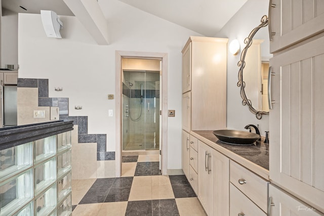 bathroom with vanity, vaulted ceiling, and an enclosed shower