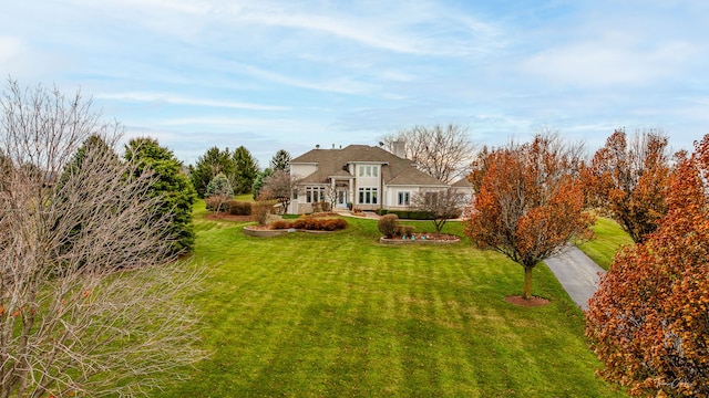 exterior space with a chimney and a yard