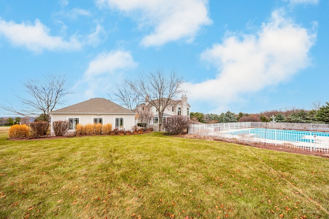 view of yard with fence and a fenced in pool