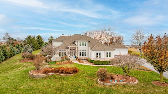 back of house with a lawn