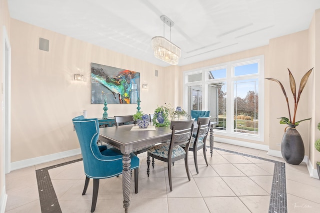 dining room with light tile patterned flooring and an inviting chandelier