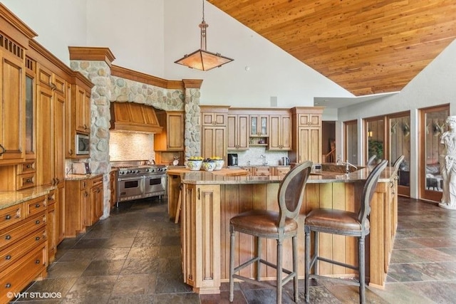 kitchen with high vaulted ceiling, a center island with sink, appliances with stainless steel finishes, custom range hood, and wood ceiling