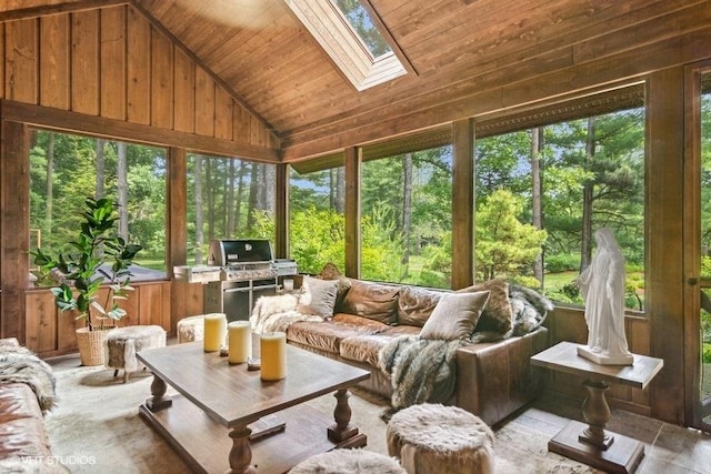 sunroom featuring vaulted ceiling with skylight and wood ceiling