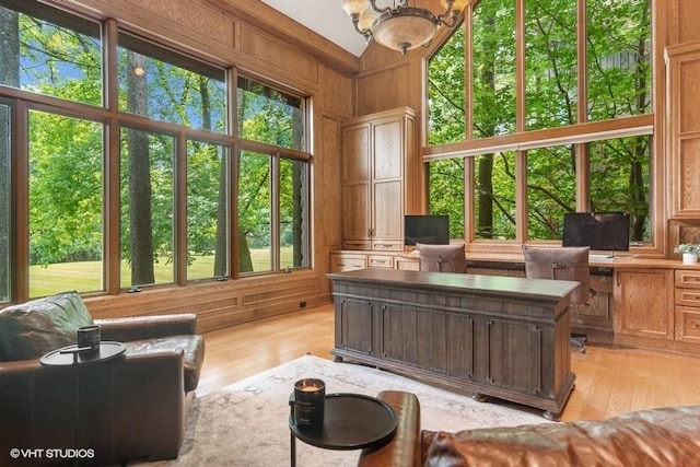 sunroom featuring a notable chandelier