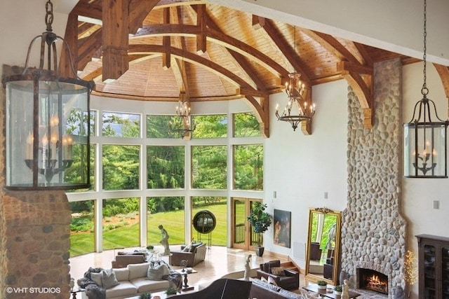 living room with beam ceiling, high vaulted ceiling, and a stone fireplace