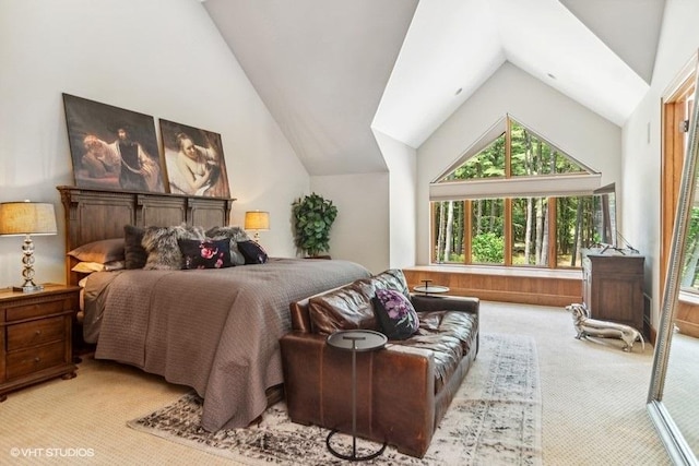 bedroom with light colored carpet and lofted ceiling