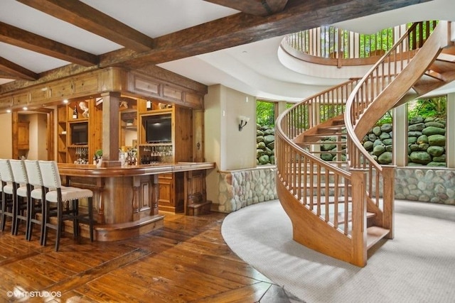 bar with dark hardwood / wood-style floors and beam ceiling