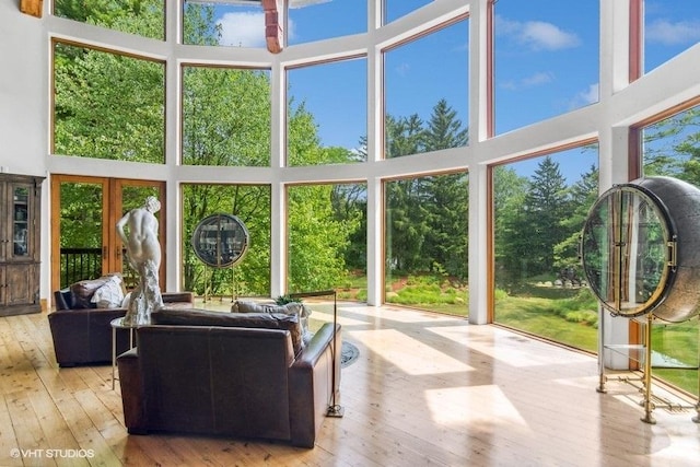 sunroom featuring french doors and a healthy amount of sunlight