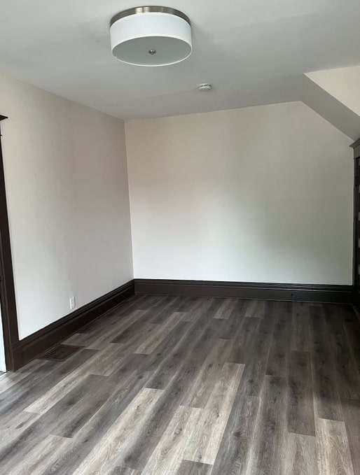 bonus room featuring dark wood-type flooring