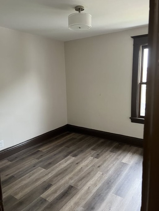 unfurnished room with dark hardwood / wood-style floors