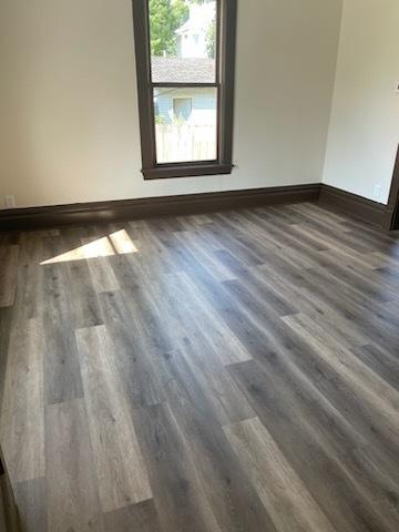 empty room with dark hardwood / wood-style floors