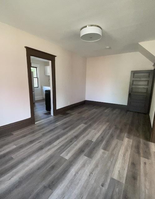 spare room with dark wood-type flooring