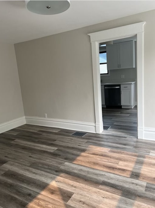 unfurnished room with dark wood-type flooring