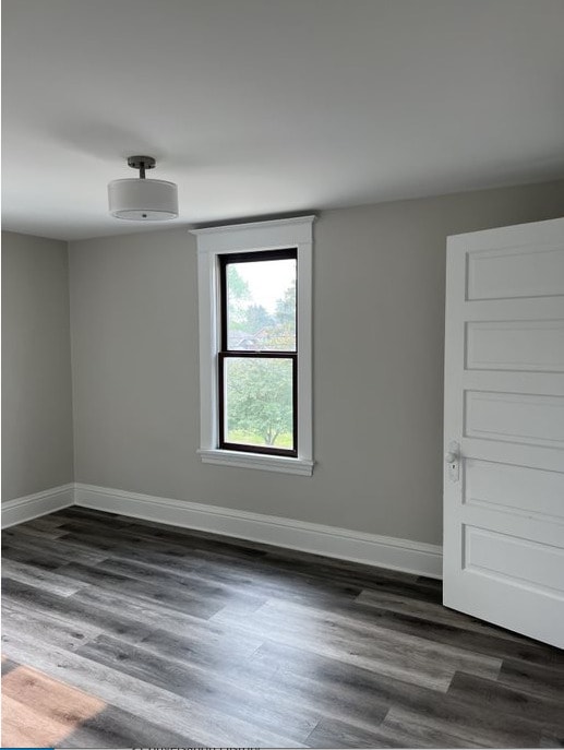 empty room with dark hardwood / wood-style floors