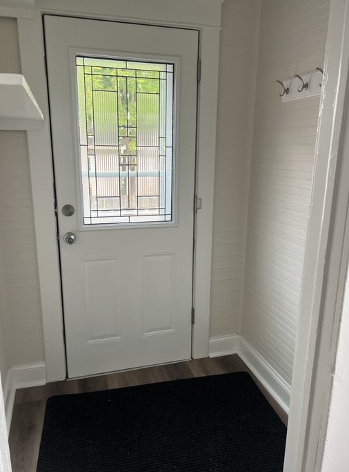 doorway to outside with dark hardwood / wood-style floors