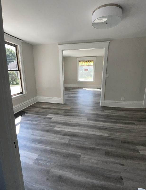 unfurnished room featuring dark hardwood / wood-style floors and a wealth of natural light