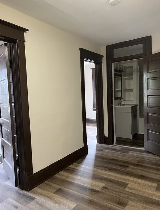 corridor featuring sink and dark hardwood / wood-style floors