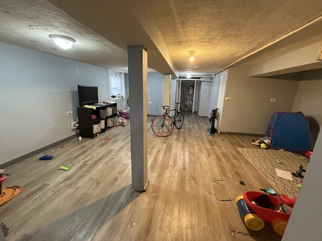 basement with a textured ceiling and light wood-type flooring