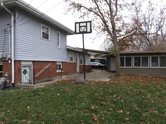 rear view of property with a patio area and a lawn