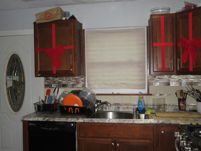 kitchen with decorative backsplash, sink, and black appliances