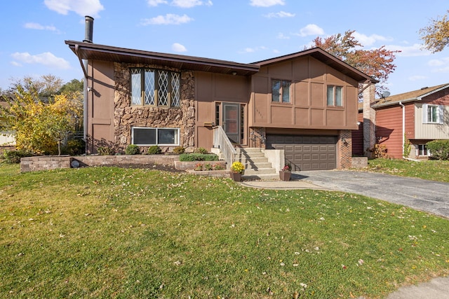 split foyer home featuring a front lawn and a garage