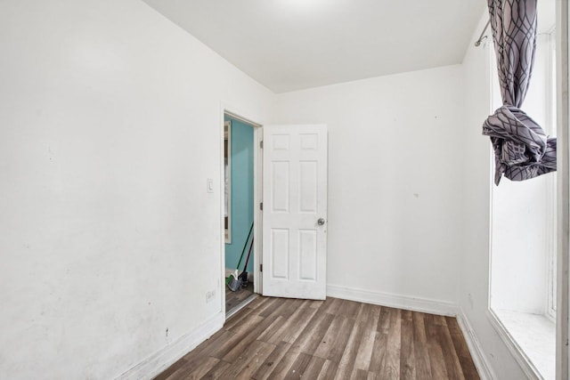 unfurnished room featuring dark hardwood / wood-style floors