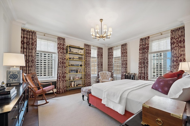 bedroom with crown molding, dark wood-type flooring, and an inviting chandelier