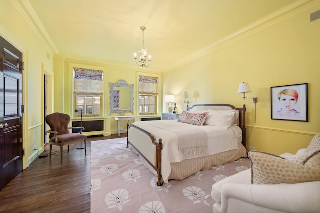 bedroom featuring hardwood / wood-style flooring, ornamental molding, radiator heating unit, and a chandelier