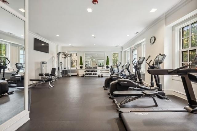 workout area featuring crown molding and a wealth of natural light