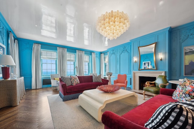 living room featuring parquet floors and a notable chandelier