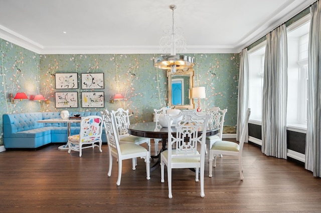 dining space with a notable chandelier, dark hardwood / wood-style floors, ornamental molding, and a healthy amount of sunlight