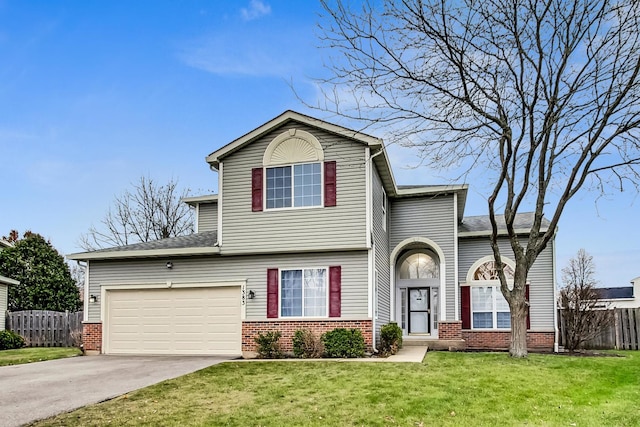 view of front of property with a front yard and a garage