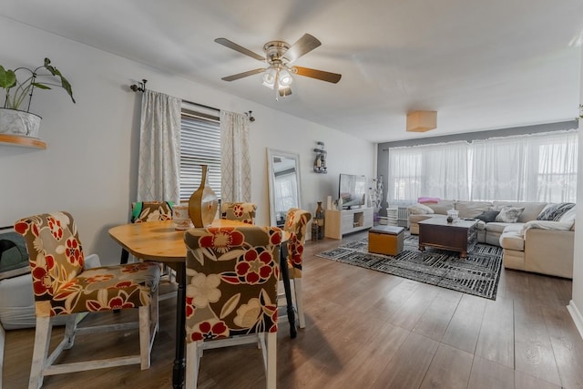 dining room with ceiling fan and hardwood / wood-style floors