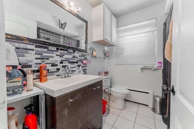 bathroom featuring toilet, tile patterned floors, decorative backsplash, vanity, and baseboard heating