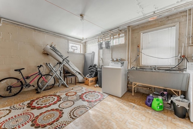 basement featuring sink and washer and clothes dryer