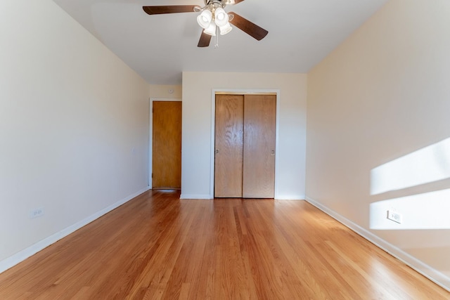 unfurnished bedroom with ceiling fan, light hardwood / wood-style floors, and a closet