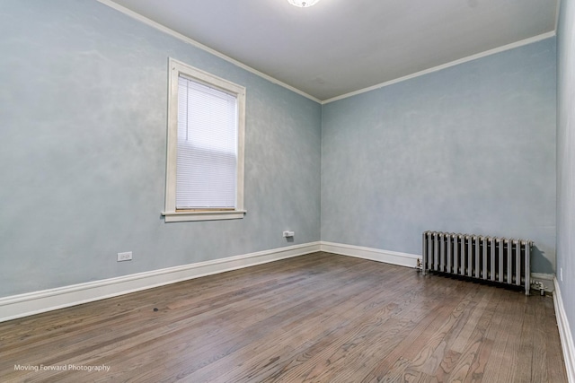 unfurnished room featuring hardwood / wood-style flooring, radiator heating unit, and ornamental molding